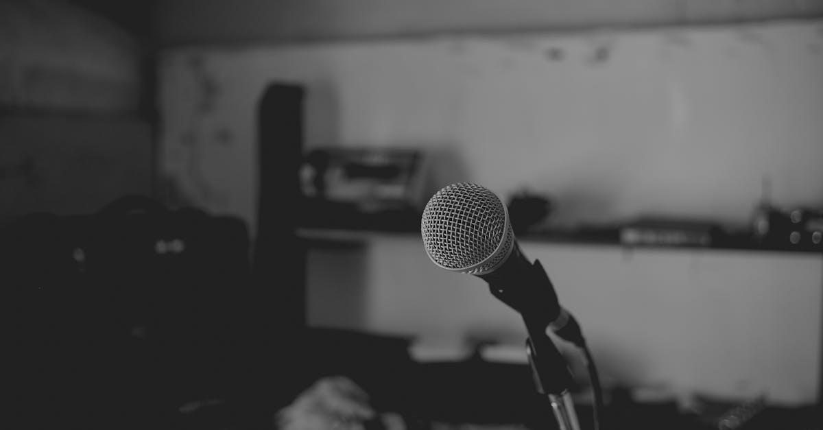 Artistic black and white shot of a music studio with a focus on a microphone. Perfect for music-themed projects.