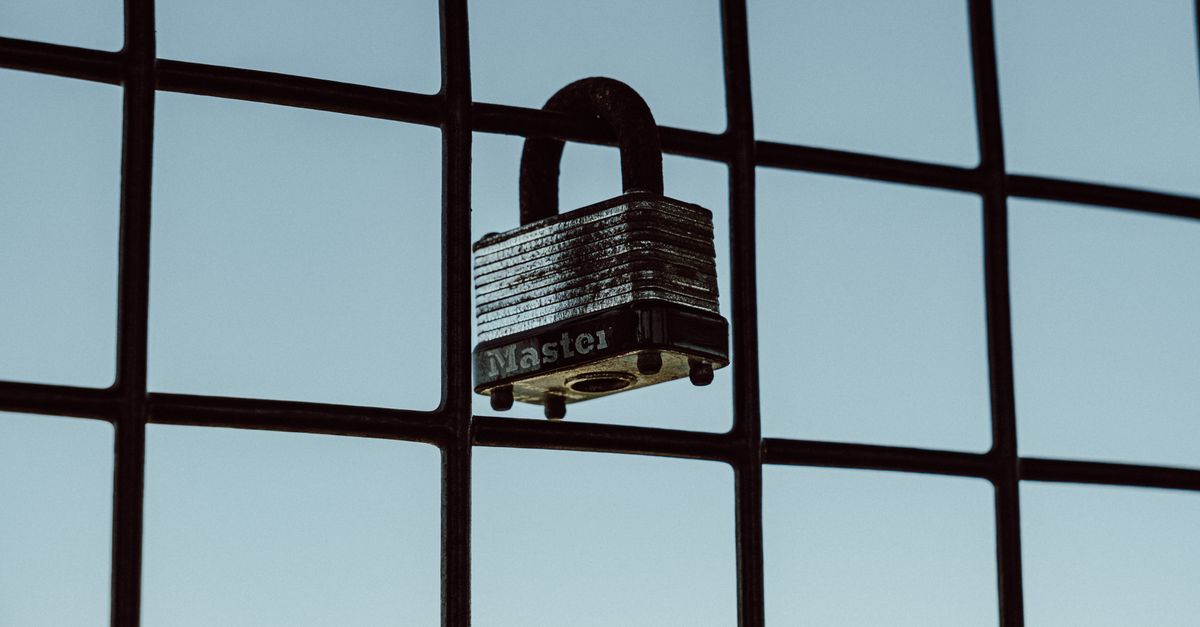 A close-up of a padlock securing a wire fence, symbolizing protection and safety.