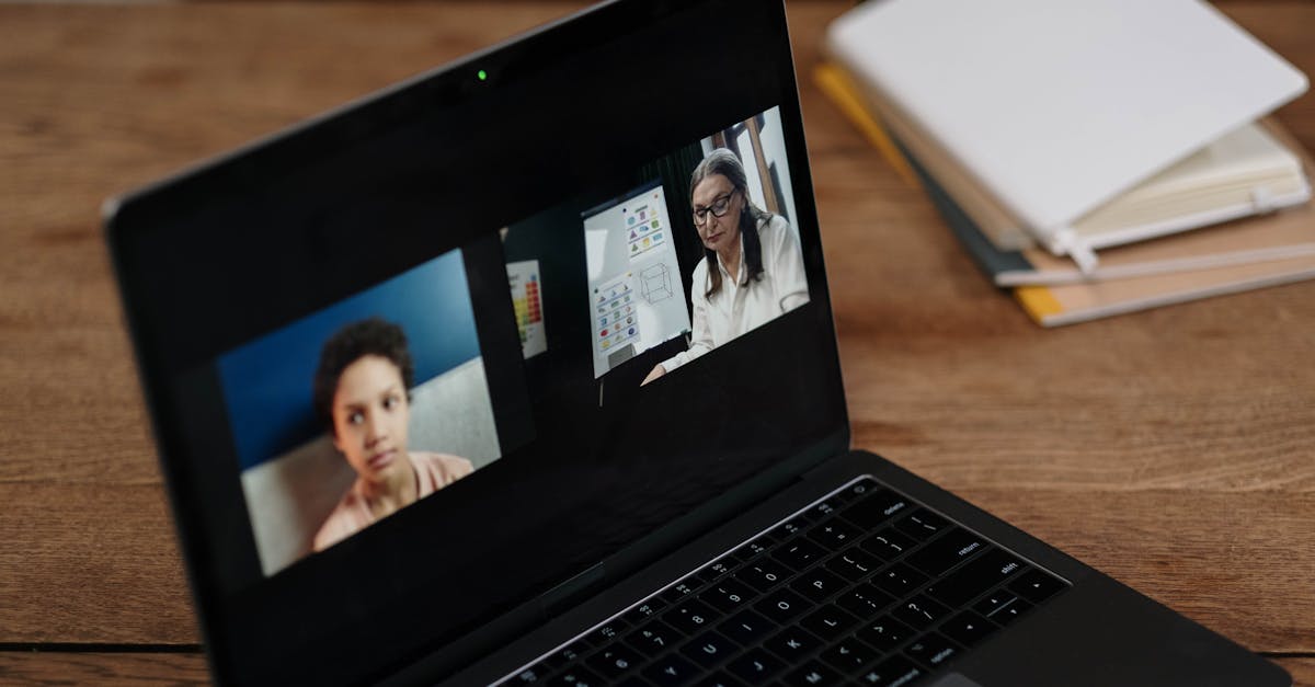 Two people engaging in online education via a laptop, perfect for illustrating virtual learning.